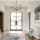 modern cozy home entry way with cupless candlestick chandeleir