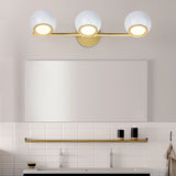 white and gold triple vanity sconce with white subway tile backsplash