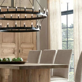 spanish style black round chandelier over dining table