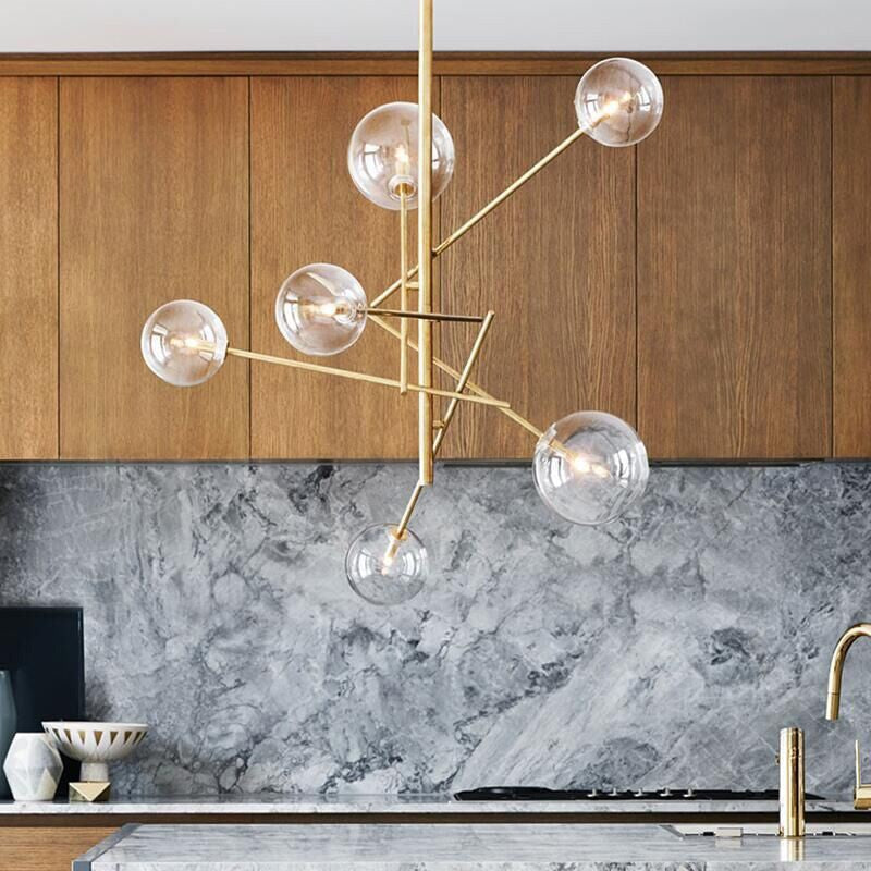 Brass bubble chandelier with clear glass globes over a kitchen counter