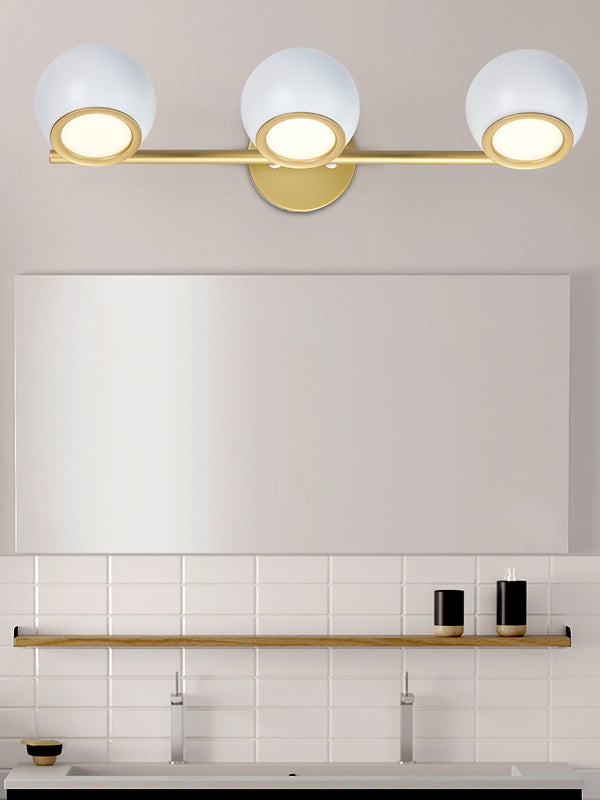 white and gold triple vanity sconce with white subway tile backsplash